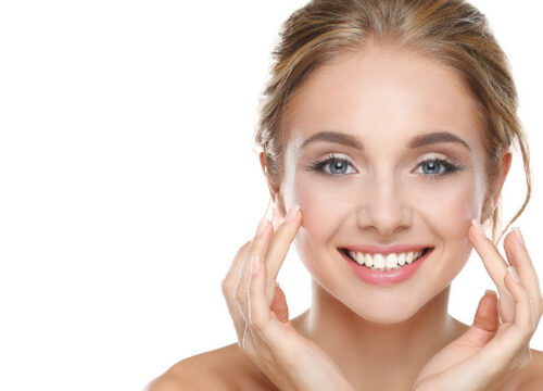 Photo of a happy woman touching her cheeks after ezGel filler treatments